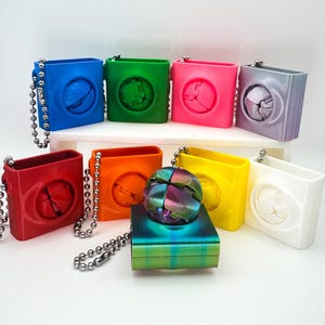 May include: A white ceramic mug with a black handle and the text "But First, Coffee" in a bold, black font. The mug is set against a blurred background, suggesting a cozy setting.