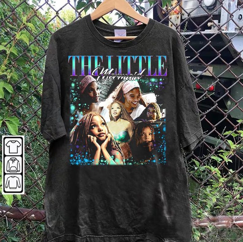 May include: Black t-shirt featuring a graphic of characters from "The Little Mermaid" movie. The design includes the movie title in purple and blue, with images of the characters in a colorful, aquatic-themed background.