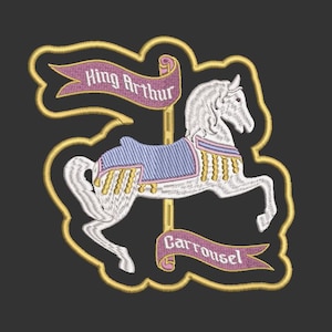 May include: Embroidered patch featuring a white carousel horse with a blue saddle and gold accents. The design includes banners that read "King Arthur" and "Carrousel" on a black background, outlined in gold.