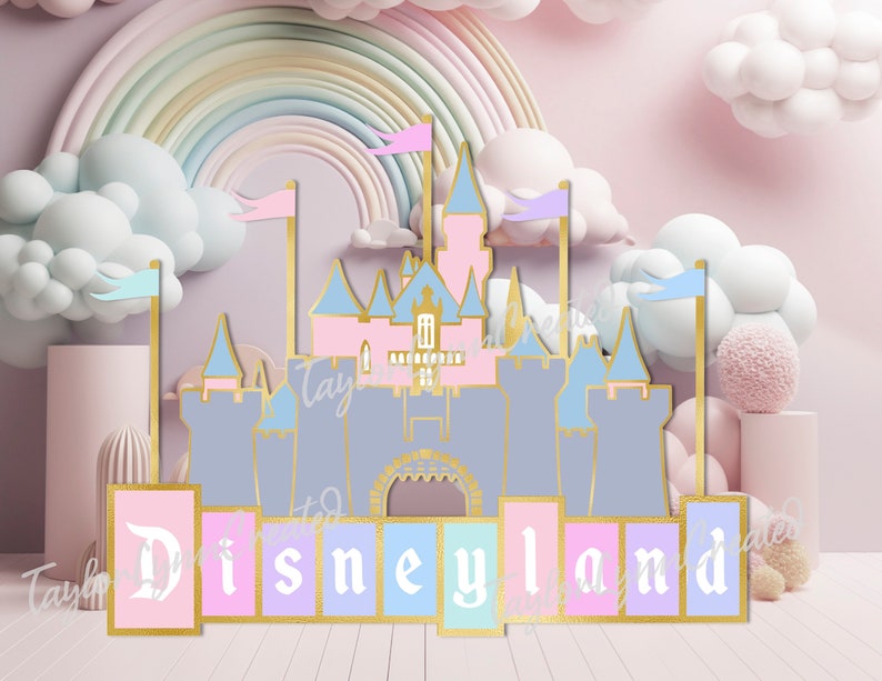 May include: A pastel-colored Disneyland castle cutout with gold accents, flags, and the word "Disneyland" in a decorative font. The castle is set against a backdrop of a rainbow, clouds, and a pink background.