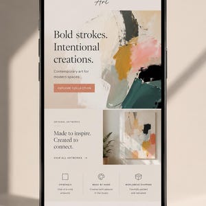 May include: A smartphone displaying a website for Anna Smith Art. The interface features a hero section with abstract painting, text reading Bold strokes. Intentional creations., and a button labeled EXPLORE COLLECTION. Below are sections for original artworks, service icons, and a featured collection.