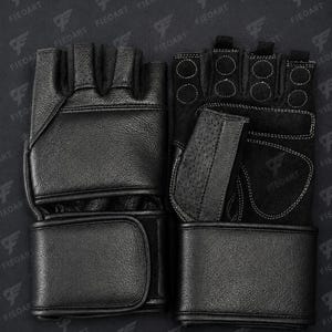 May include: A pair of black fingerless gloves featuring a textured leather exterior, a wide wrist strap with a hook-and-loop closure, and a palm side with reinforced stitching, circular padding details, and a perforated leather section.
