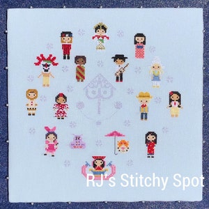May include: A cross-stitch pattern featuring a circle of various Disney princesses and characters, including Snow White, Cinderella, Belle, Ariel, Mulan, Pocahontas, Tiana, Rapunzel, and Moana. The pattern is on a light blue background with a purple tree in the center. The text "RJ's Stitchy Spot" is at the bottom of the pattern.