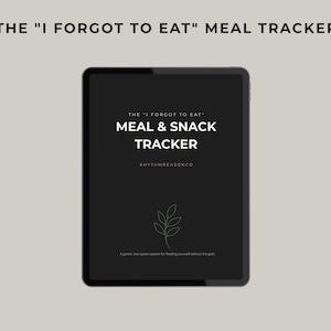 May include: A black tablet displays the text "THE 'I FORGOT TO EAT' MEAL & SNACK TRACKER" in white. Below the title is the text "RHYTHMREASONCO" and a small leaf illustration. The tablet is set against a light gray background.