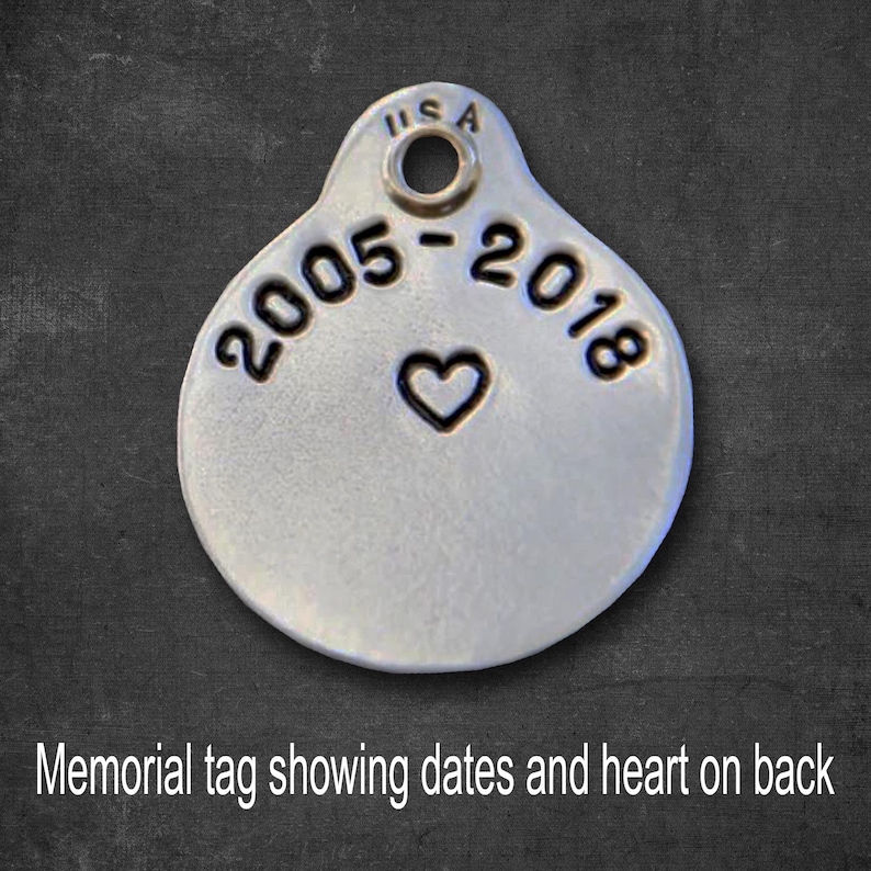 May include: Silver memorial tag with the dates "2005-2018" and a heart engraved on the back.