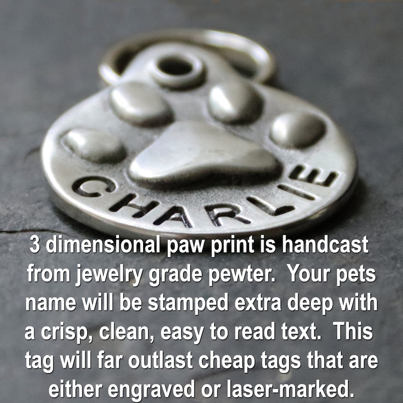 May include: Silver paw print pet ID tag with the name "CHARLIE" engraved on it. The tag is 3-dimensional and hand cast from jewellery grade pewter.