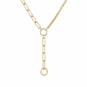 May include: A gold-colored necklace with a Y-shaped design. The necklace features a combination of chain styles, including a curb chain and a series of rectangular links. The necklace has a circular pendant at the top and bottom of the Y-shape.