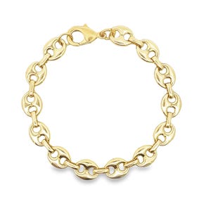 May include: A gold-colored chain bracelet with a lobster clasp. The bracelet features a series of oval-shaped links, each with a central indentation, creating a bean-like appearance. The bracelet is displayed against a white background.
