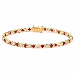 May include: A gold tennis bracelet featuring an alternating pattern of round, bezel-set red rubies and clear white diamonds. The bracelet is constructed with individual circular metal settings linked together and includes a secure box clasp closure.