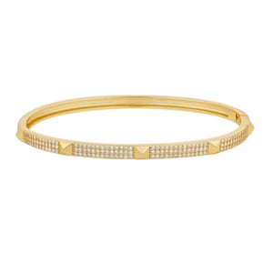 May include: A gold bangle bracelet featuring a continuous band with a pavé-set surface of small clear stones. The design includes evenly spaced, smooth gold pyramid-shaped studs integrated into the band, creating a textured and reflective appearance.