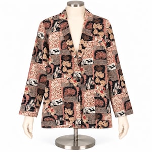 May include: A long-sleeve blazer featuring a multi-panel patchwork design with various botanical and abstract patterns in shades of black, brown, tan, and muted red. The garment has a notched lapel, a single front button closure, and a straight hem.