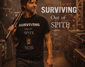 May include: A man in a black t-shirt with the words "SURVIVING Out of SPITE" printed on it, holding a metal tool. The image also features the same text in a larger font. The shirt has a Road Crew Collection tag.