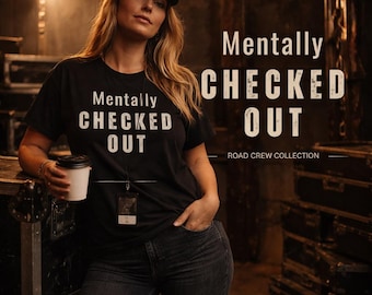May include: A white ceramic mug with a black handle and the text "But First, Coffee" in a bold, black font. The mug is set against a blurred background, suggesting a cozy setting.