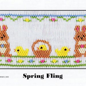 May include: A white embroidery pattern with a spring theme. The pattern features two brown bunnies, each holding a flower, and three yellow chicks. One chick is in a brown basket with a yellow handle. The pattern is surrounded by green leaves and pink, yellow, and blue flowers. The text "Spring Fling" is printed below the pattern.