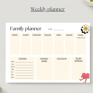 May include: A cream-colored family planner with sections for each day of the week, meal planning, shopping lists, and notes. The planner includes the text "Weekly planner" and "Family planner". Decorative elements include a smiling daisy and a heart character.