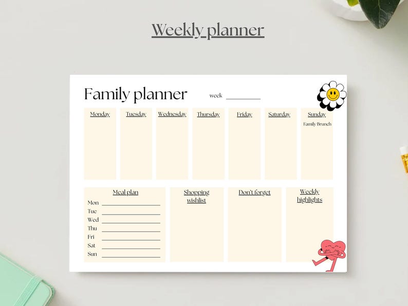 May include: A cream-colored family planner with sections for each day of the week, meal planning, shopping lists, and notes. The planner includes the text "Weekly planner" and "Family planner". Decorative elements include a smiling daisy and a heart character.