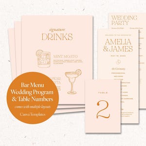 May include: A collection of wedding stationery in a soft peach color, including a bar menu, wedding program, and table number. The bar menu features a cocktail illustration and the text "signature DRINKS". The wedding program includes the names "AMELIA & JAMES".