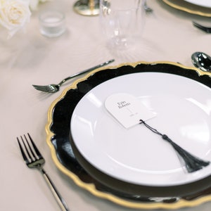 Rehearsal dinner name cards and place setting in gold and black.