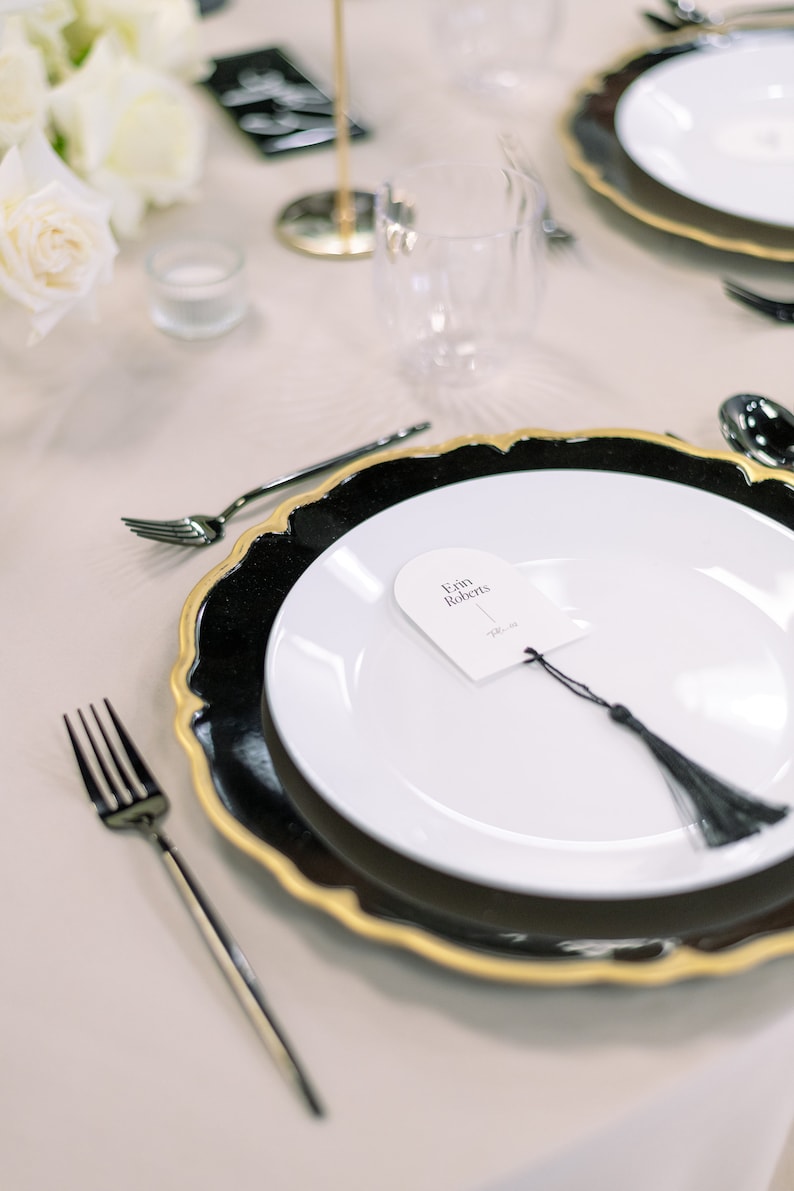 Rehearsal dinner name cards and place setting in gold and black.