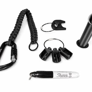 Puede incluir: Un surtido de accesorios negros, que incluyen un mosquet&oacute;n con un cord&oacute;n trenzado, llaveros y un soporte cil&iacute;ndrico. Tambi&eacute;n se incluye un marcador Sharpie negro con el nombre de la marca.