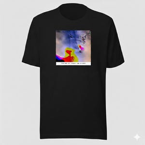 May include: Black t-shirt featuring a colorful abstract design on the front. The design includes red, yellow, blue, and white elements. The text "TLA.COM - LAT @ JONNY - LOW. LAT SMOKE" is printed below the design.