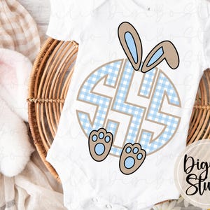 May include: White baby bodysuit featuring a blue and tan Easter bunny design. The design includes a blue gingham monogram, bunny ears, and paws. The DigiBo Studio logo is in the lower right corner.