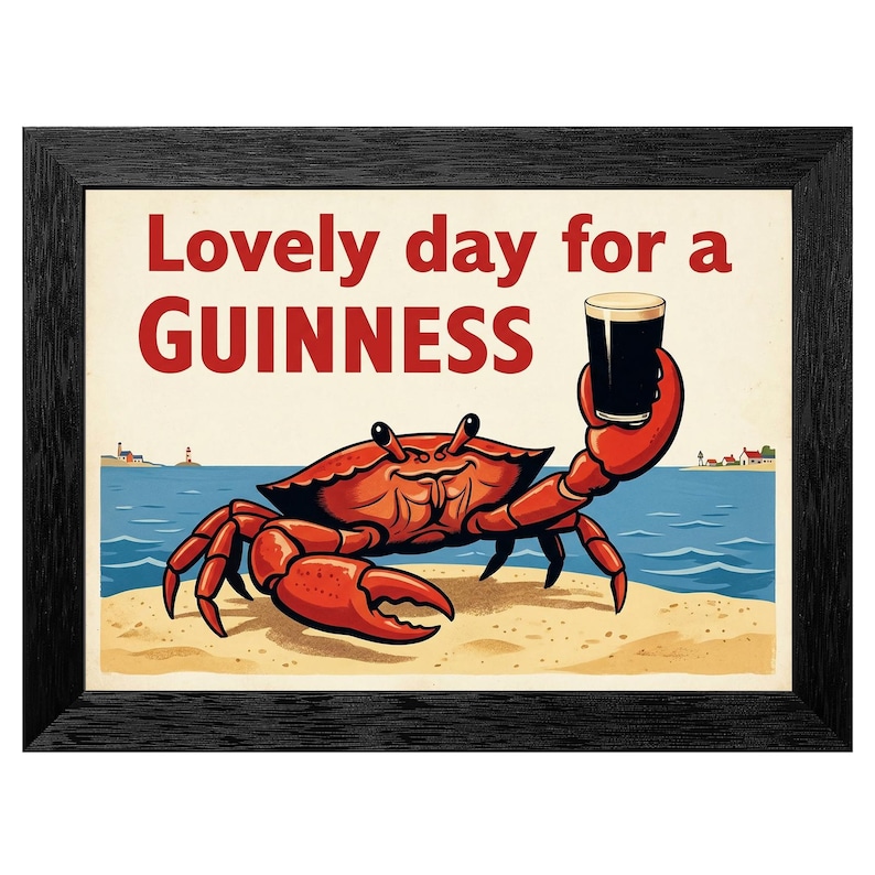 May include: A framed print featuring a cartoon crab on a beach, holding a pint of Guinness. The text "Lovely day for a Guinness" is displayed in red above the crab. The artwork has a vintage, nautical theme.