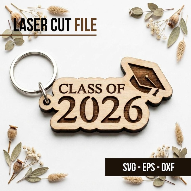 May include: A wooden keychain with the text "CLASS OF 2026" and a graduation cap design. The keychain is attached to a silver metal ring. The words "LASER CUT FILE" and "SVG - EPS - DXF" are also visible.