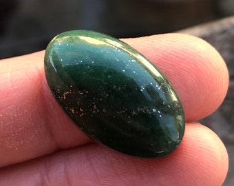 black gemstone with gold flecks