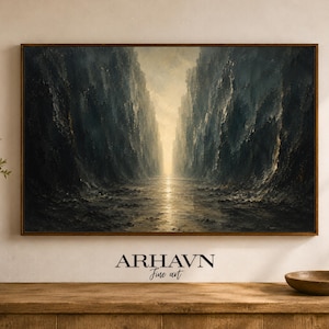 May include: A framed landscape painting depicts a narrow canyon with towering, textured walls in shades of blue and gray. A bright, golden light emanates from the end of the canyon. The artwork is signed "ARHAVN Fine art".
