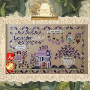 May include: A cross-stitch pattern titled "Lavender Farm" featuring a purple house, lavender plants, and a farmer. The design includes the text "Lavender Farm" and "Dried Lavender". The image is framed with a decorative lace border.