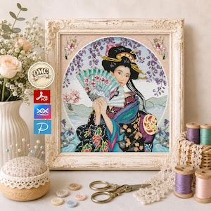 May include: A framed cross-stitch pattern featuring a person with dark hair in an updo, wearing a black and blue patterned kimono and holding a light blue folding fan. The circular design includes purple wisteria flowers and a landscape background.