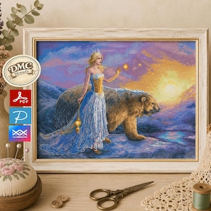 May include: A framed cross-stitch artwork shows a woman in a blue gown with a polar bear against a sunset. The image includes the DMC threads logo and PDF, P, and XX symbols.