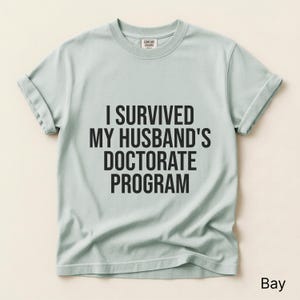 I Survived My Husband's Doctorate Program Shirt, Gift For Wife, Funny PHD Graduation Tee, PHD Dissertation Tshirt, Grad Gag Shirt