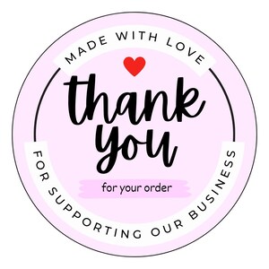 May include: A circular sticker with a light pink background featuring the black text thank you in a script font. Above the text is a small red heart and the words MADE WITH LOVE. Below the text is for your order and FOR SUPPORTING OUR BUSINESS.