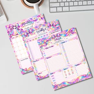 May include: Three paper planner sheets featuring a pastel rainbow galaxy theme with iridescent ribbons, bows, and stars. The pages include sections for Monthly Planner, Weekly Planner, and Today with headers, checklists, and mood trackers in pink and blue.