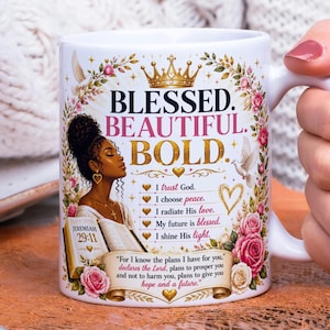 May include: A white ceramic mug featuring a graphic of a Black woman with an afro holding an open Bible. The text reads BLESSED. BEAUTIFUL. BOLD. along with Jeremiah 29:11 and other inspirational phrases, surrounded by gold crowns, doves, and pink roses.