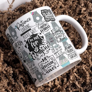 May include: White ceramic mug with a humorous design featuring grumpy cat illustrations and sarcastic phrases. The mug includes text like "Patience Loading..." and "I'm not for everyone." The mug is inside a box with brown paper filler.