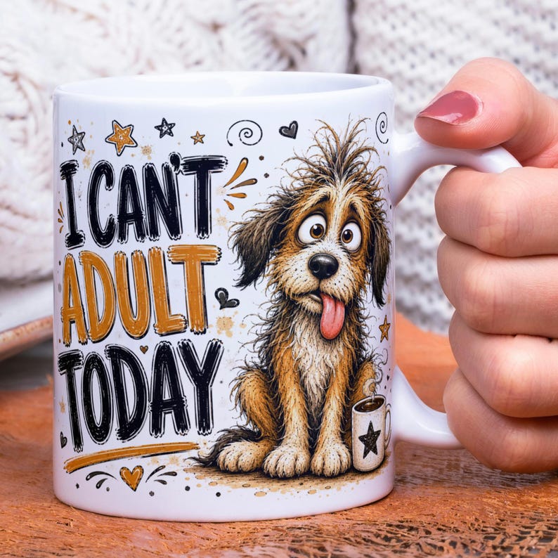 May include: A white ceramic mug featuring a cartoon illustration of a shaggy brown dog with wide eyes and its tongue sticking out. The text "I CAN'T ADULT TODAY" is printed in black and gold lettering alongside small star, heart, and swirl graphics.