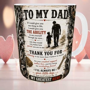 May include: White ceramic mug with a printed design. The design includes the text "TO MY DAD", a silhouette of a father and child, and other text. The mug has a white handle and a decorative border.