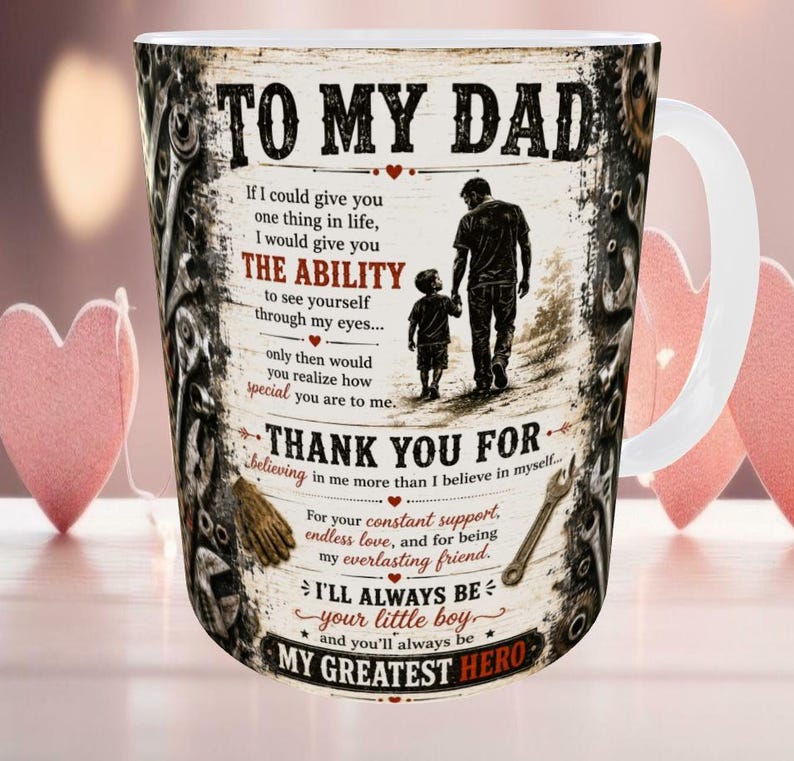May include: White ceramic mug with a printed design. The design includes the text "TO MY DAD", a silhouette of a father and child, and other text. The mug has a white handle and a decorative border.