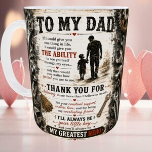 May include: White ceramic mug with a wraparound design featuring the text "TO MY DAD" and a heartfelt message. The design includes a silhouette of a father and child, tools, and decorative elements. A perfect gift.