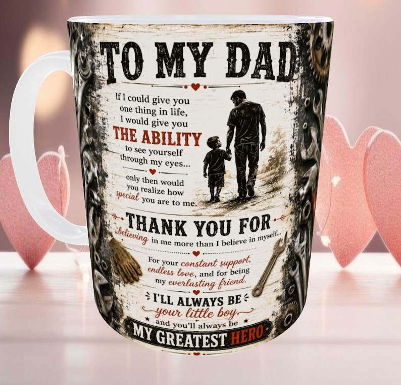 May include: White ceramic mug with a wraparound design featuring the text "TO MY DAD" and a heartfelt message. The design includes a silhouette of a father and child, tools, and decorative elements. A perfect gift.