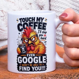 Op de afbeelding: Witte keramische koffiemok met een humoristisch ontwerp. De mok heeft een cartoonhaan met een bril die een koffiekopje vasthoudt. De tekst op de mok luidt: "Touch My Coffee, I'll slap you so hard, even Google won't be able to find you!!!"
