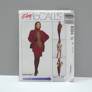 May include: A vintage McCall's sewing pattern featuring a woman in a red skirt suit and coat. The pattern includes multiple wardrobe options. The text on the pattern reads "Easy McCall's", "Petite-Able", and "Non-Stop Wardrobe".