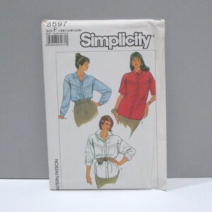 May include: A vintage Simplicity sewing pattern packet, featuring illustrations of button-down shirts. The packet is white with the Simplicity logo and pattern number 8597. The illustrations show shirts in blue, red, and white.