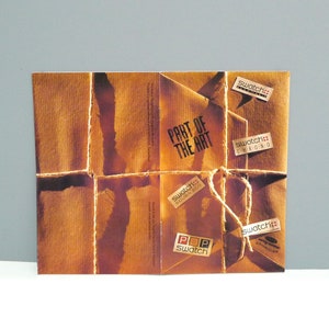 May include: A brown paper package tied with twine, featuring the text "PART OF THE ART." Several "Swatch" stickers are affixed, including "SCUBA 200," "CHRONO," and "POP Swatch." The package has a vintage aesthetic.