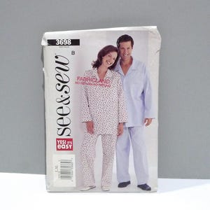 May include: A sewing pattern package featuring a couple in pajamas. The package has the text "see & sew" and "YES! it's easy". The woman is wearing a white pajama set with a black pattern, and the man is wearing a light blue pajama set.