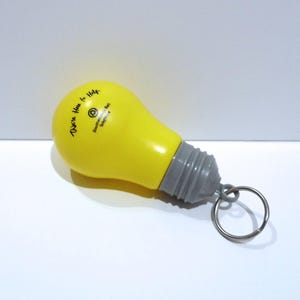 Southwestern Bell Telephone Light bulb Keychain  - We&#39;re Here For Life - 60s 70s - Opens up / Secret Compartment /SW Bell Bag Backpack Charm