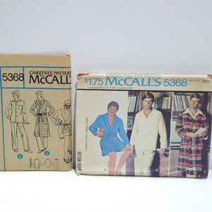 May include: Two vintage McCall's sewing pattern envelopes. The patterns are for men's robes and pajamas. The envelopes are beige and feature illustrations of the garments. The text "5368" and "Carefree Patterns" are visible.